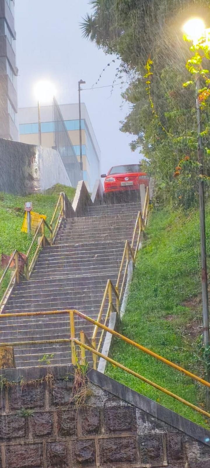 Motorista erra caminho durante temporal e veículo cai em escadaria de Erechim